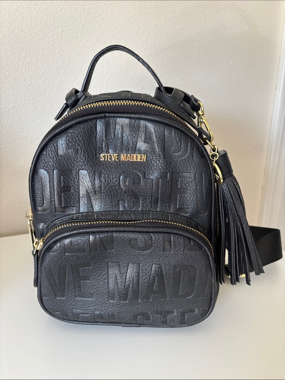 Steve Madden Black Embossed Logo Mini Backpack with Tassel